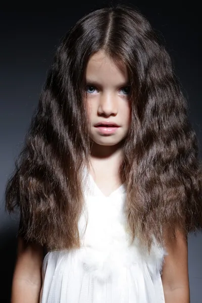 Portrait of young beautiful little girl with dark hair — Stock Photo, Image