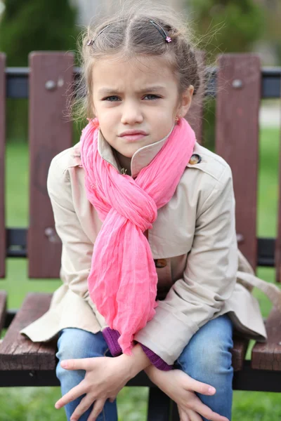 Portrait of a beautiful girl in a pink scarf — Stock Photo, Image