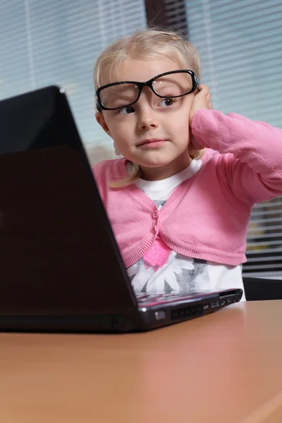 Little girl with laptop in office — Stock Photo, Image