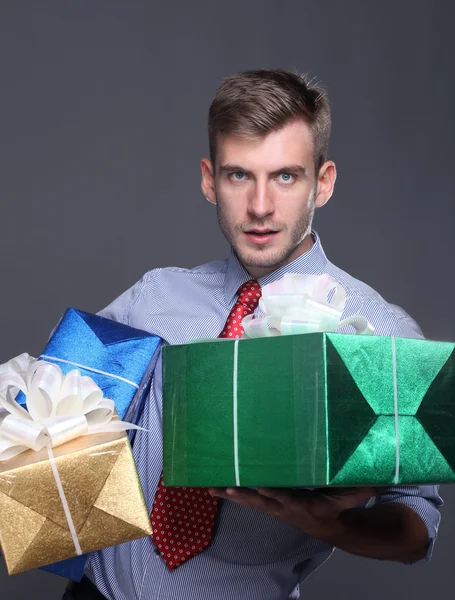 Portrait of young business man with gifts — Stock Photo, Image