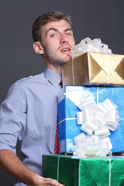 Portrait of young business man with gifts — Stock Photo, Image