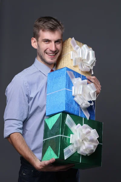 Portrait of young business man with gifts — Stock Photo, Image