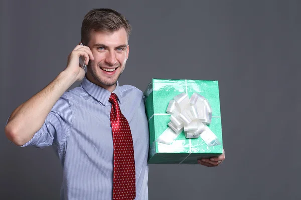 Portrait of young business man with gifts — Stock Photo, Image