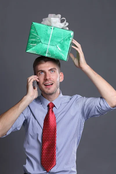 Portrait of young business man with gifts — Stock Photo, Image