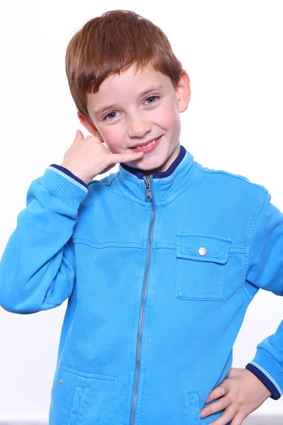 Beautiful little boy making a call me gesture — Stock Photo, Image