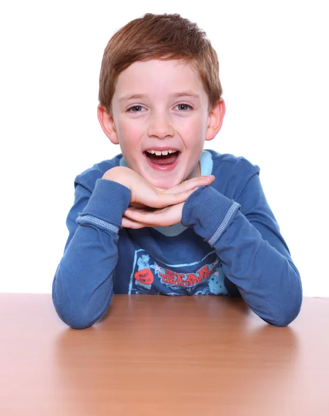 Beautiful little boy sitting at the table — Stock Photo, Image