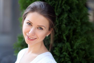 Güzel genç kız gülümsüyor.