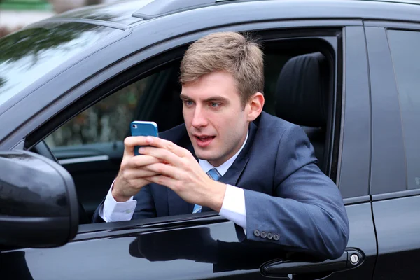 Telefon ederken çekici genç bir adam — Stok fotoğraf