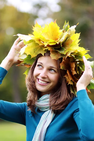 Beautiful woman with a bouquet of maple leaves Stock Picture