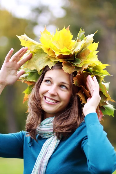 Beautiful woman with a bouquet of maple leaves Stock Picture