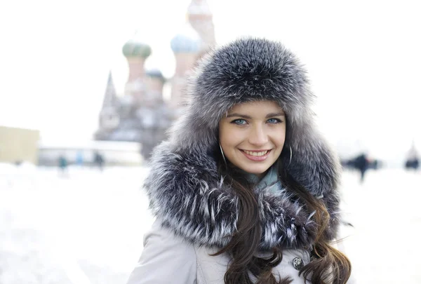 Portrait d'une jeune femme sur fond de ville hivernale — Photo