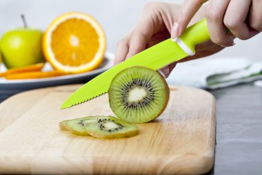 Kadının elleri taze kivi mutfak üzerinde kesme