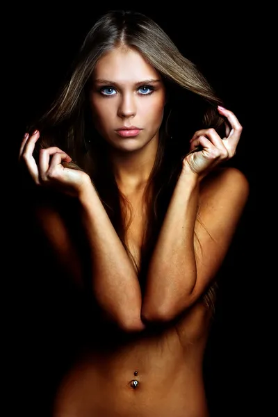 Sexy naked young woman in dark studio — Stock Photo, Image