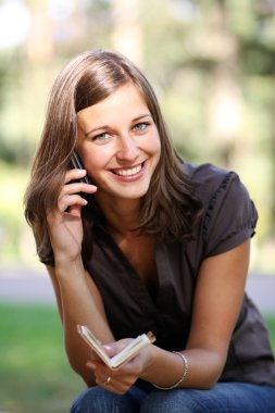 mutlu genç bir kadın telefon ederken