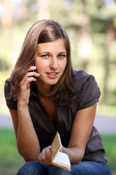 Happy young woman calling by phone — Stock Photo, Image