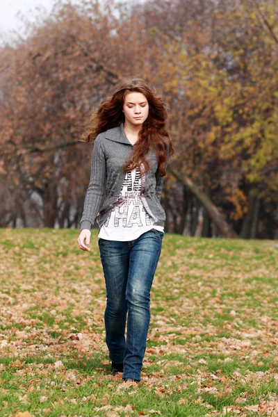 Walking woman in autumn park Stock Photo
