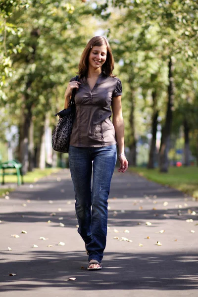 Beautiful young lady in blue jeans — Stock Photo, Image