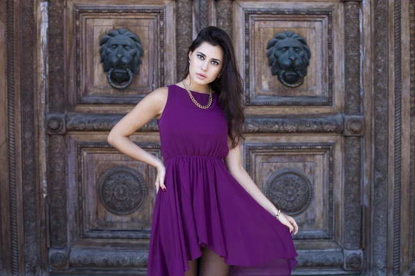 Young beautiful woman in a burgundy dress — Stock Photo, Image