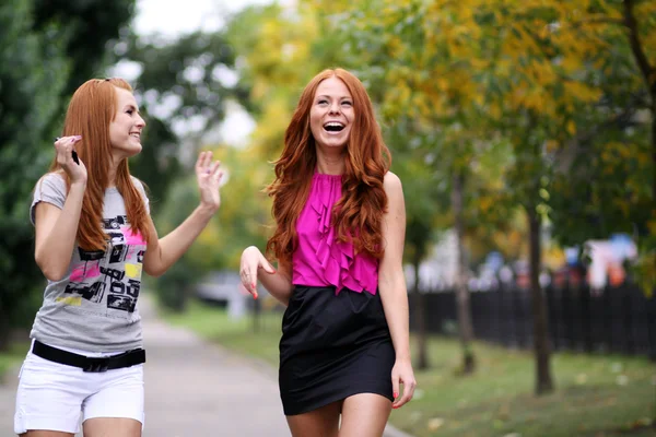 Happy two young women in autumn city — Stock Photo, Image