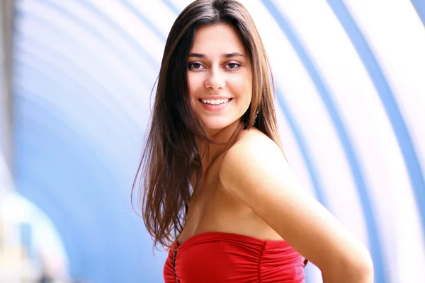 Beautiful young woman in a red dress — Stock Photo, Image