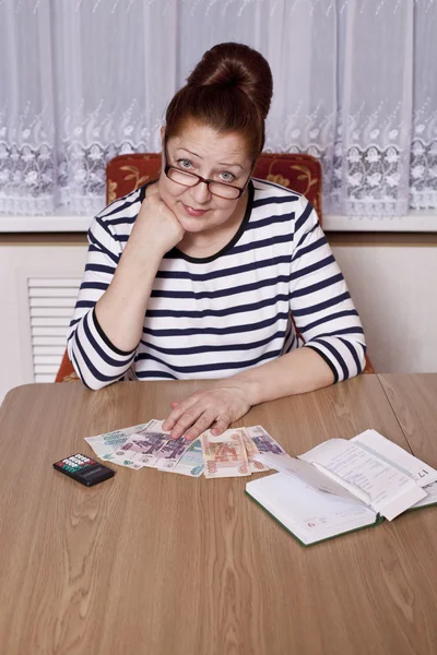 Äldre kvinna med pengar i hand — Stockfoto