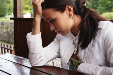 Closeup portrait of young woman looking depressed clipart