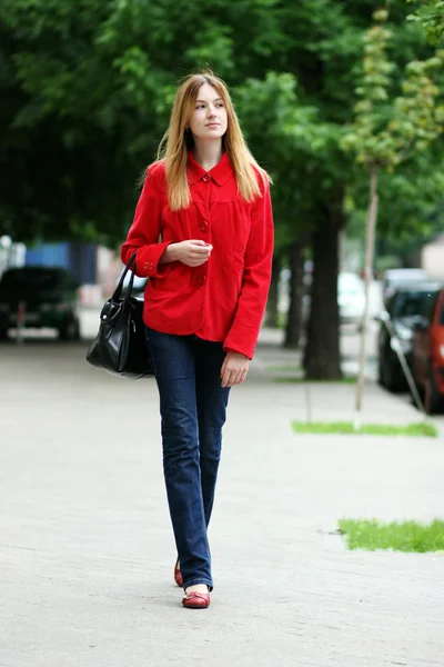 Full length portrait of a young lady walking outdoor — Stock Photo, Image