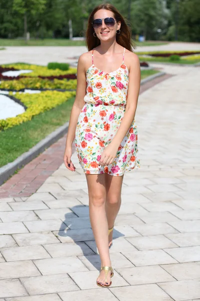 Mooie jonge vrouw lopen op de zomer park — Stockfoto