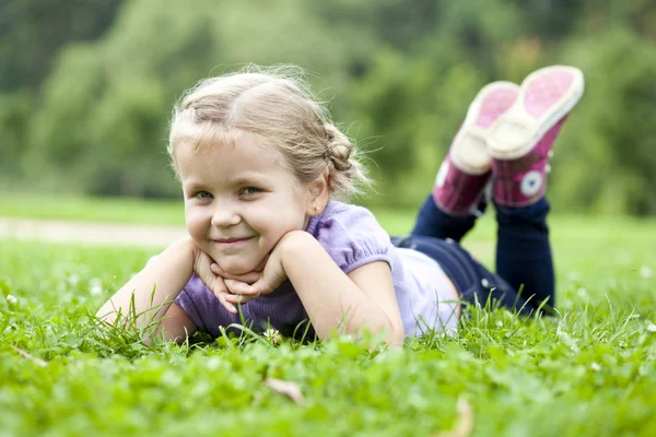 Cute little girl on the meadow in summer day — Stock Photo, Image