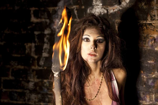 Mysterious Amazon with torch in hand — Stock Photo, Image