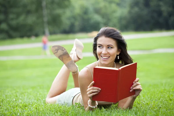 Young beautiful young woman reading a book outdoor Royalty Free Stock Images