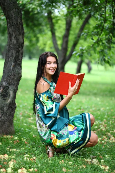 Blonde girl reading a book in the park — Stock Photo, Image