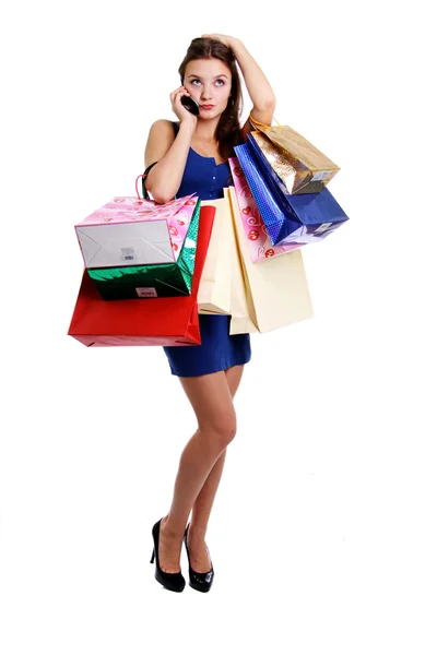 Happy young adult woman with colored bags — Stock Photo, Image