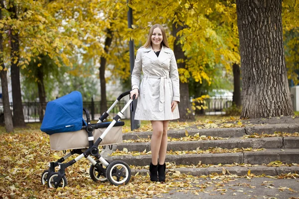 Mother with baby stroller for a newborn — Stock Photo, Image