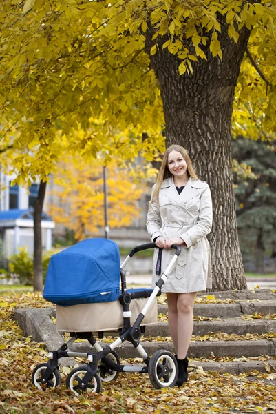 Mother with baby stroller for a newborn — Stock Photo, Image