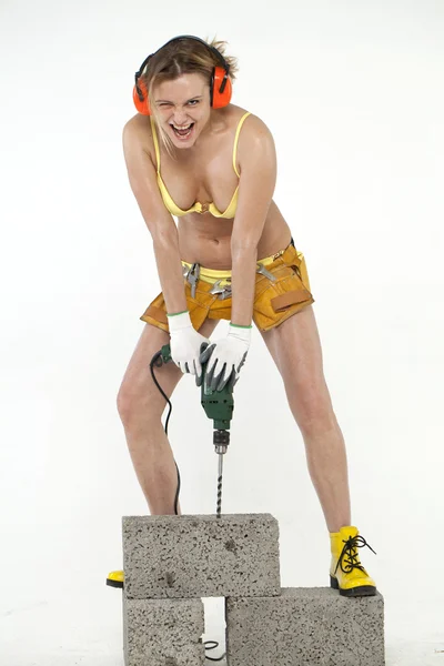 Mujer sexy sosteniendo un taladro de construcción —  Fotos de Stock