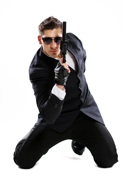 Men in black suit holding gun — Stock Photo, Image