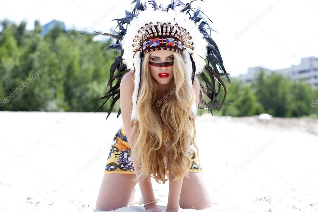 Blonde woman in costume of American Indian