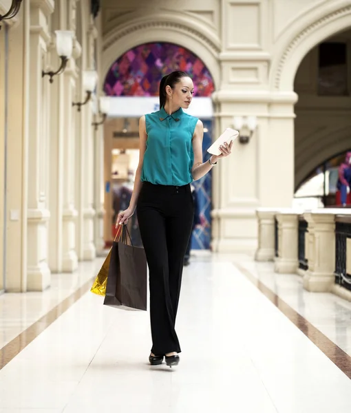 Happy young woman walking in the shop — Stock Photo, Image