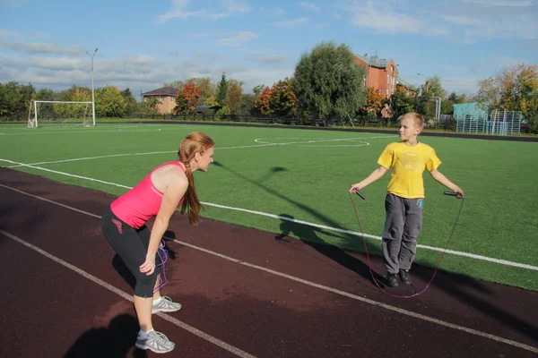 Спортивные мать и сын занимаются фитнесом — стоковое фото