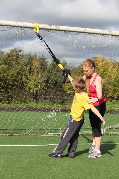 Sportliche Mutter und Sohn im Fitnessbereich engagiert — Stockfoto