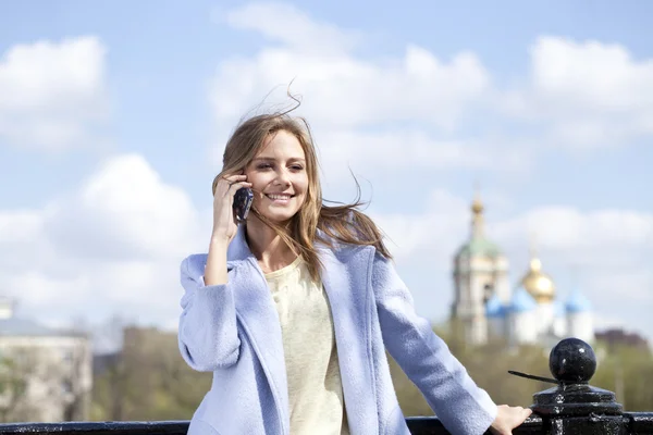 Happy young woman calling by phone — Stock Photo, Image