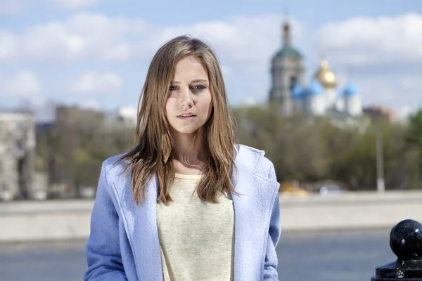 Stylish young woman in a blue coat — Stock Photo, Image