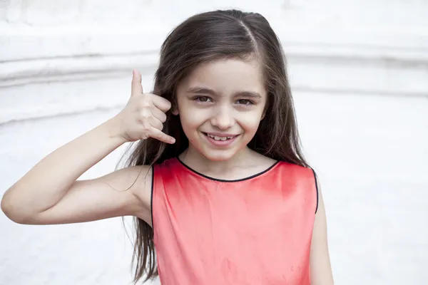 Little girl making a call me sign — Stock Photo, Image