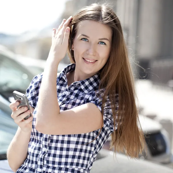 Glad kvinna läser ett meddelande på telefonen — Stockfoto