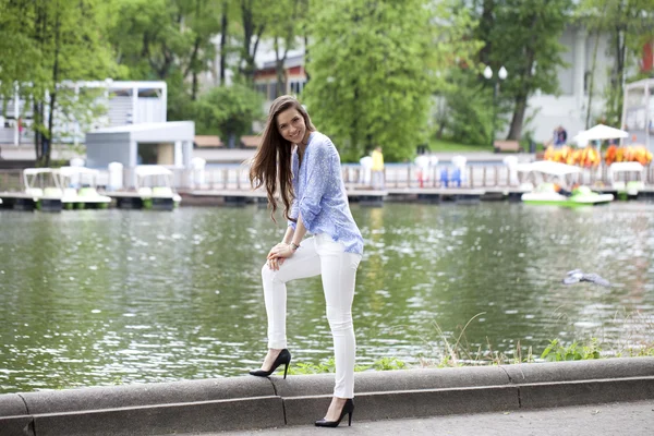 Retrato de larga duración de una hermosa mujer en pantalones blancos y blu —  Fotos de Stock