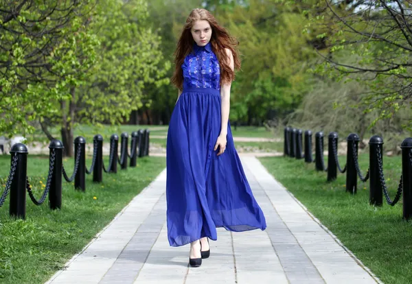 Beautiful red hair girl in a blue dress — Stock Photo, Image