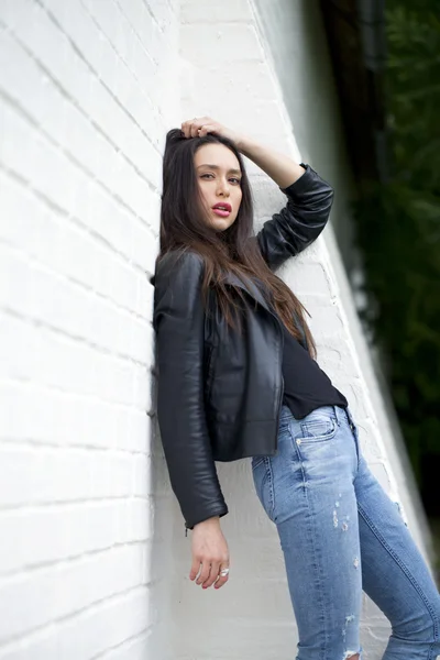Mulher sexy em jaqueta de couro e jeans azuis — Fotografia de Stock