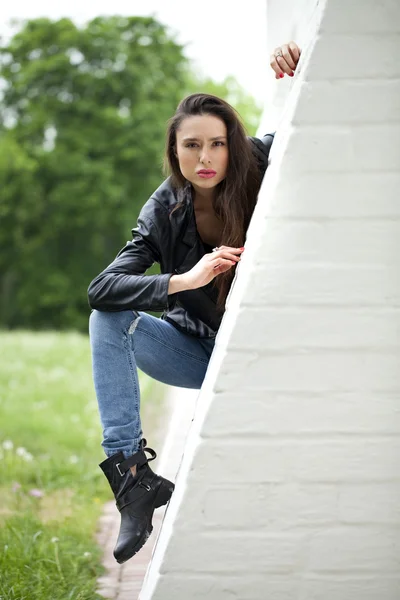 Sexy woman in leather jacket and blue jeans — Stock Photo, Image