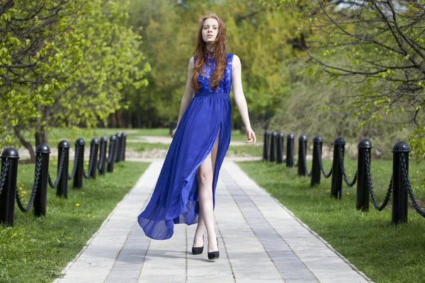 Beautiful red hair girl in a blue dress — Stock Photo, Image